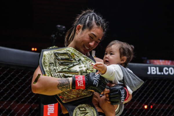 Angela Lee celebrates her successful defense of the ONE Atomweight World Championship with her daughter, Ava Marie