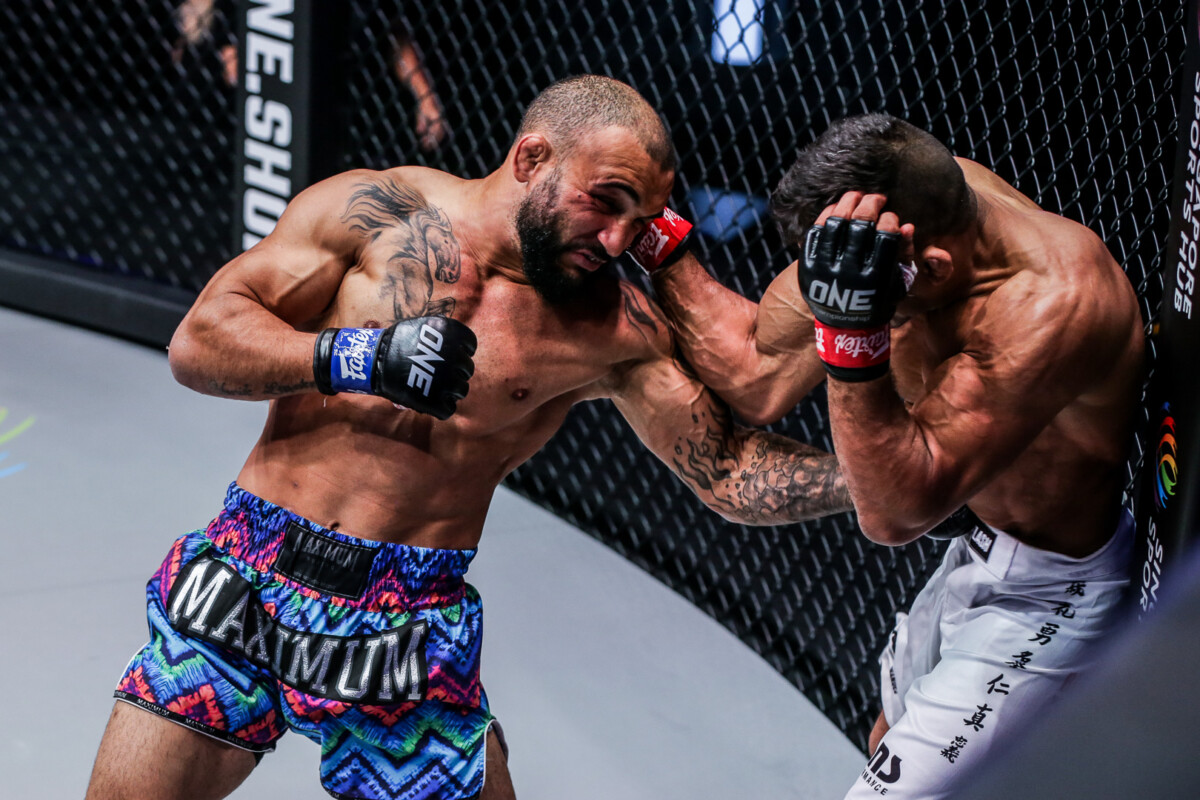 John Lineker with a body punch to Bibiano Fernandes during their match for the ONE Bantamweight World Championship at ONE: LIGHTS OUT
