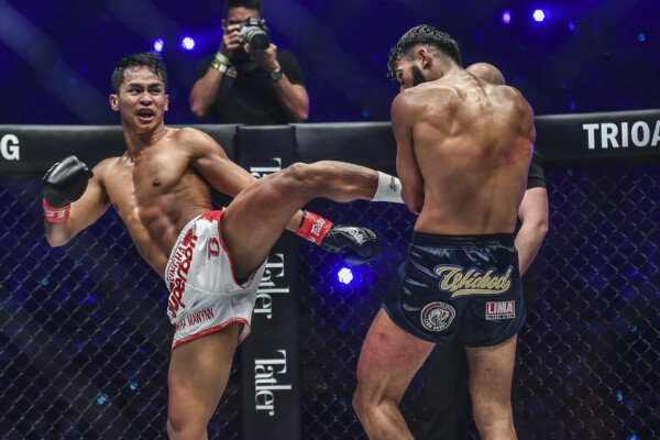 Superbon scores on a kick to Marat Grigorian's body during their fight for the Featherweight Kickboxing World Championship at ONE X