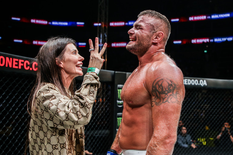Anatoly Malykhin celebrates with his wife, Anita, after becoming a three-division MMA World Champion.