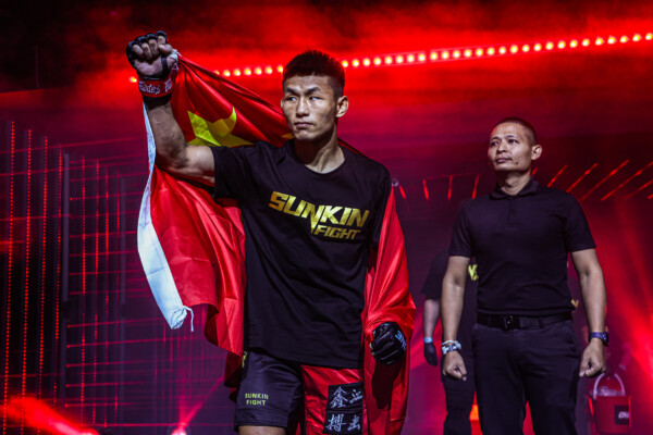 Tang Kai carries China’s national flag during his walkout at ONE Fight Night 27 in January 2025.
