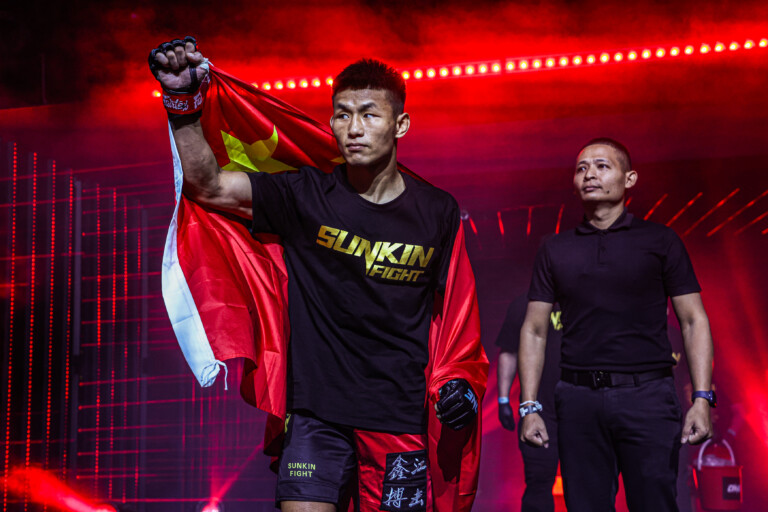 Tang Kai carries China’s national flag during his walkout at ONE Fight Night 27 in January 2025.
