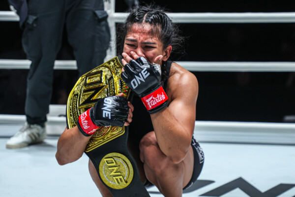 Denice Zamboanga in tears after capturing the interim atomweight MMA world title against Alyona Rassohyna.