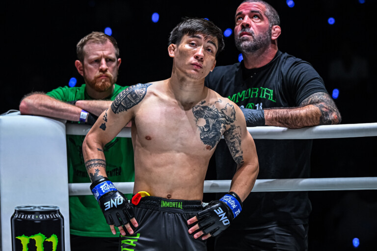 MMA fighter Joshua Perreira stands in the ring corner with Matt Browb behind him