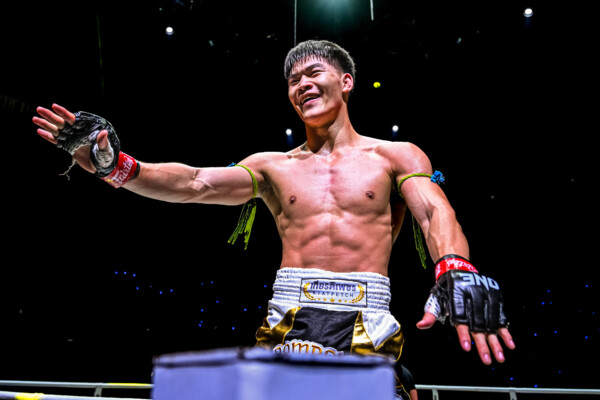 Rambolek Chor Ajalaboon stands on the turnbuckle and celebrates his win