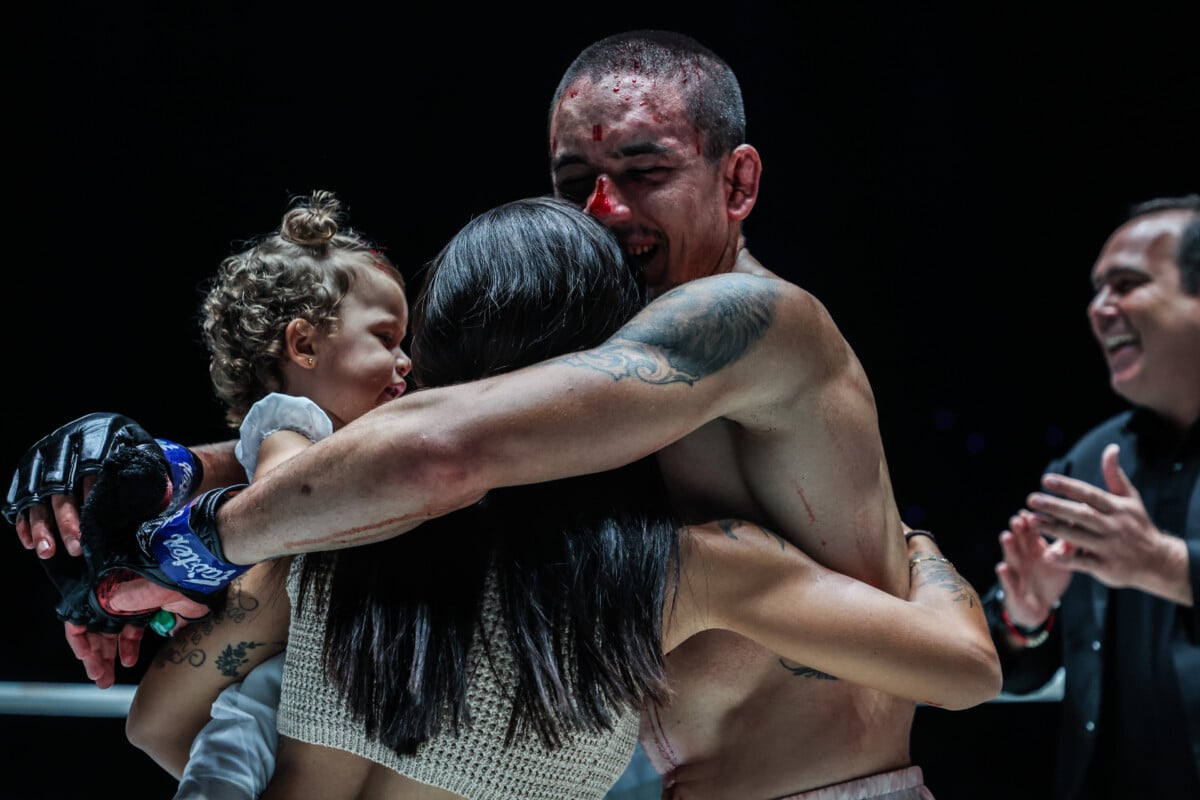 Lucas Gabriel inside the ONE Championship ring with his wife and daughter.