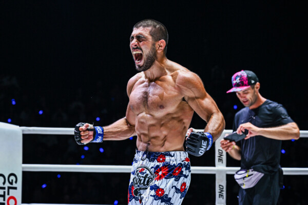 MMA fighter Elbek Alyshov celebrates his win in the ring