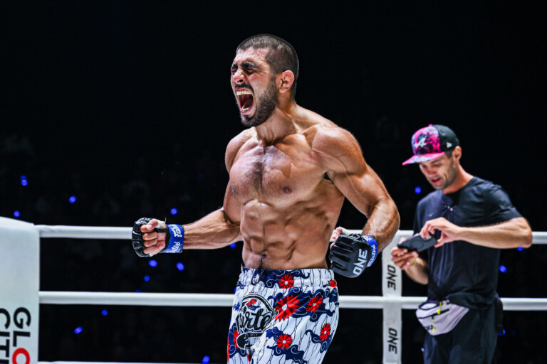 MMA fighter Elbek Alyshov celebrates his win in the ring