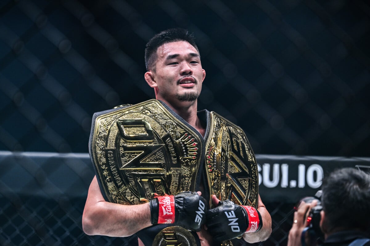 Christian Lee holds his lightweight and welterweight MMA belts.