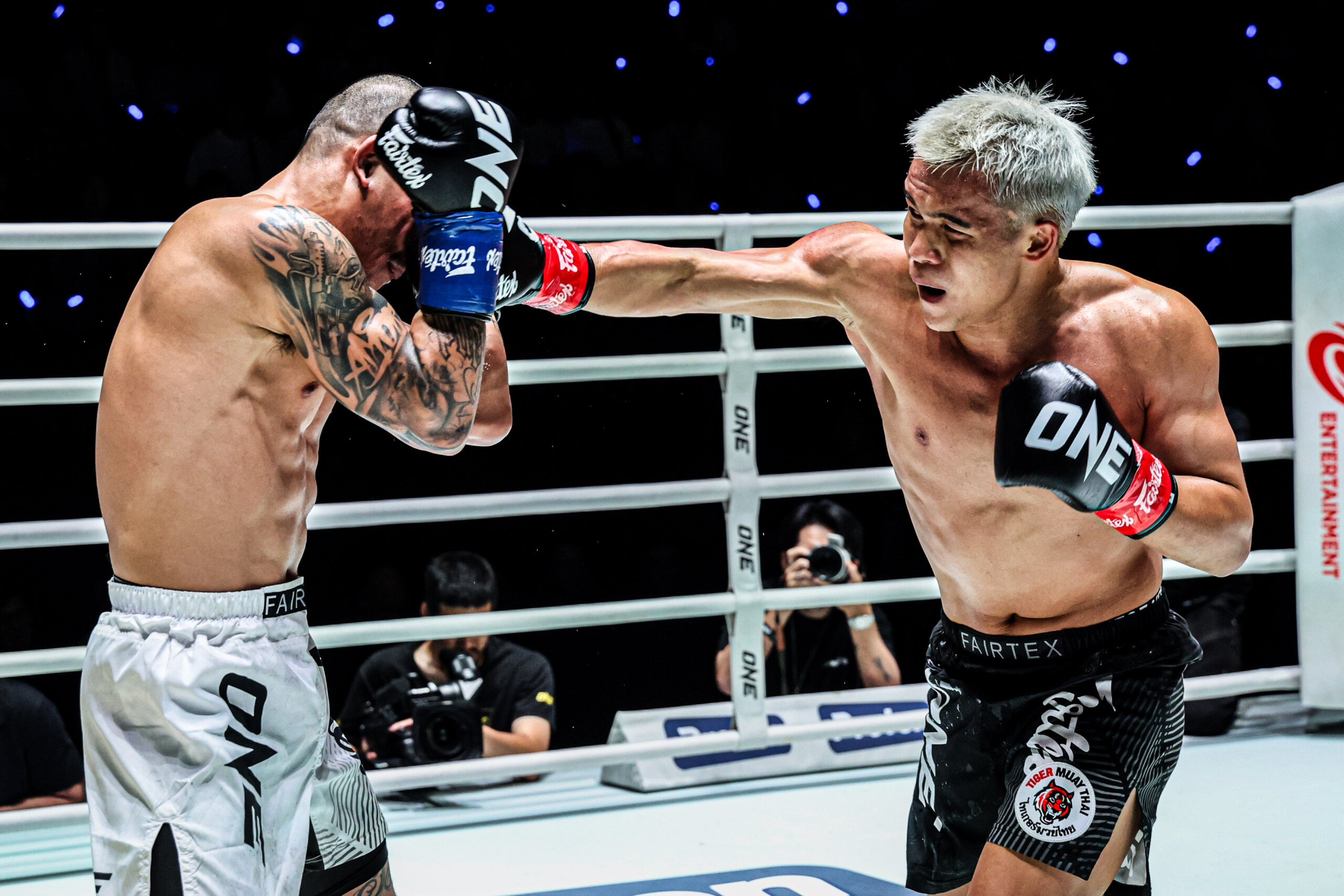 Zhang Peimian punches Thongpoon PK Saenchai in the ring