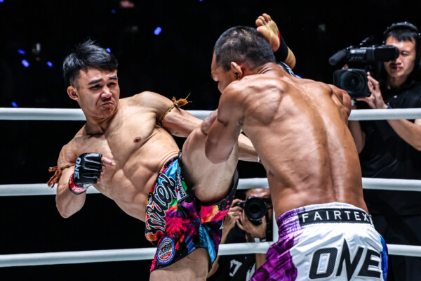 Muay Thai fighter Worapon Lukjaoporongtom lands a head kick on Soe Lin Oo