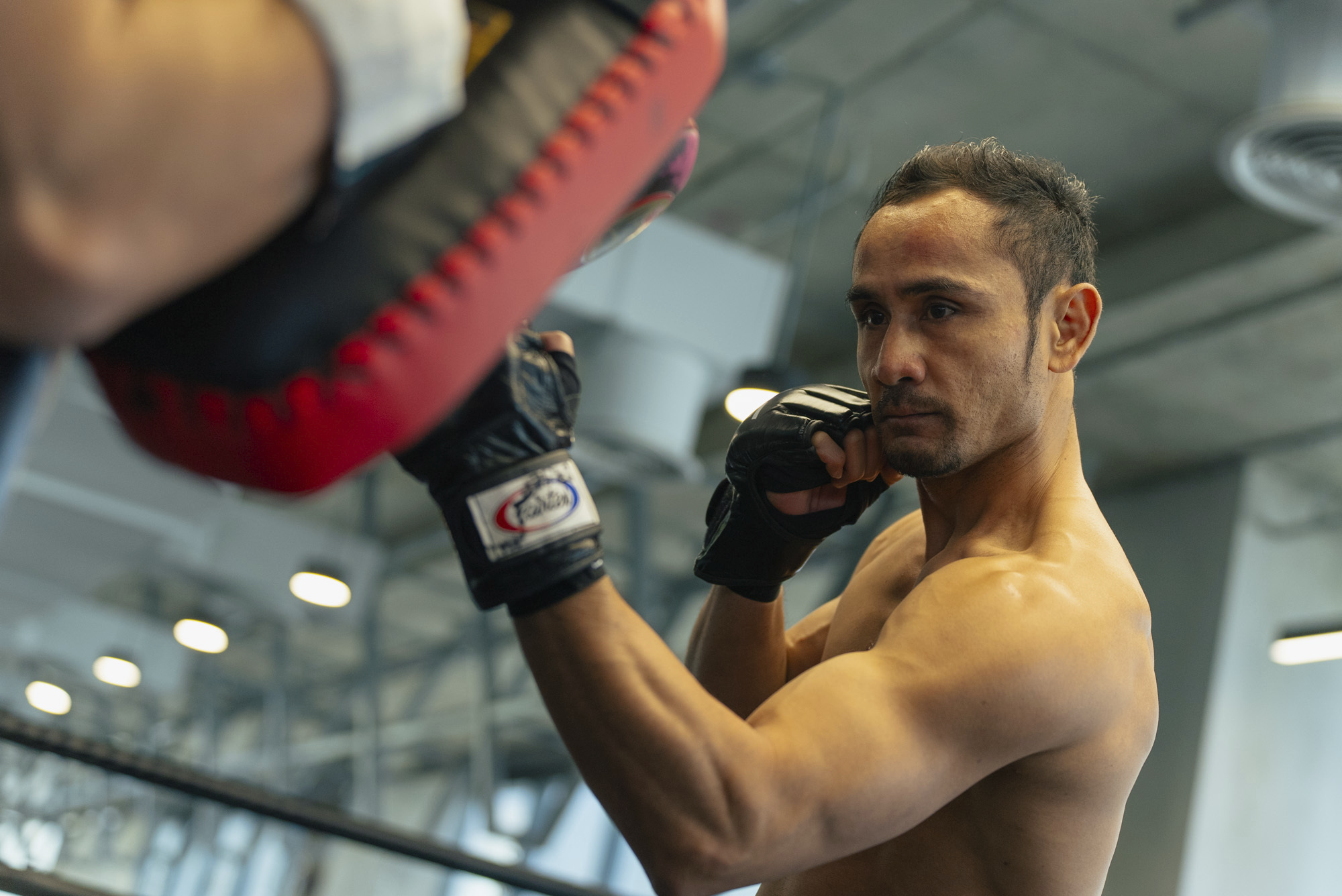 Muay Thai legend Sam A Gaiyanghadao punches the pads at Evolve MMA