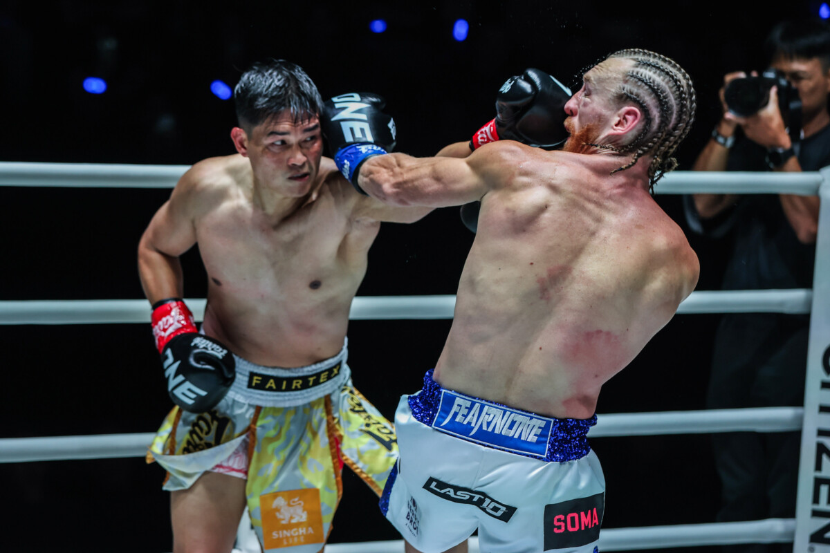Petchtanong Petchfergus tades punches with Ben Woolliss