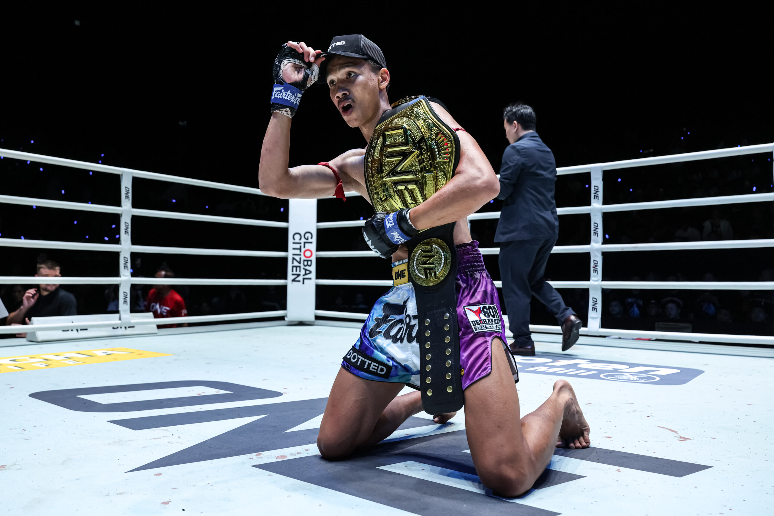 Aliff Sor Dechapan kneels in the ring and poses with the ONE Championship belt