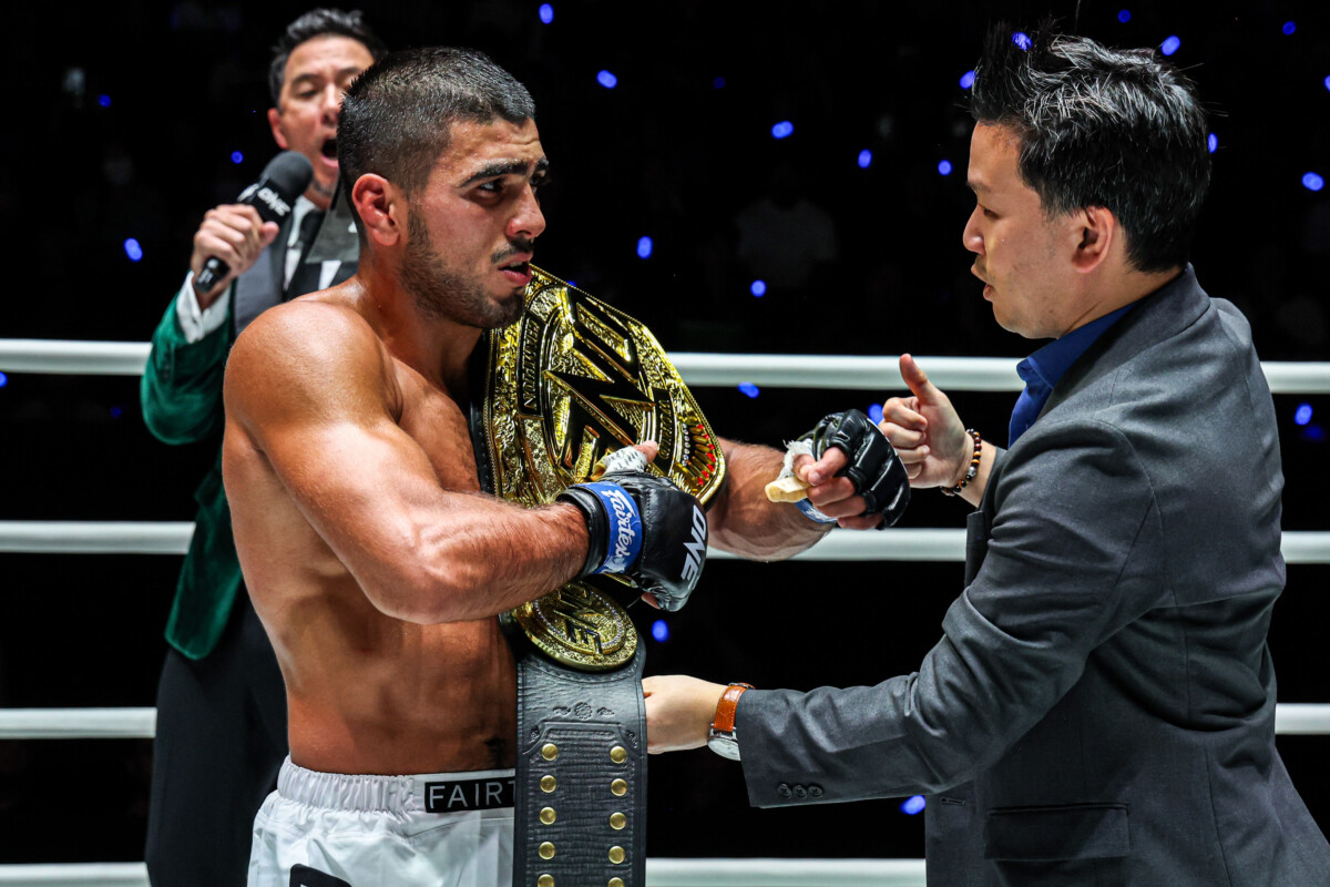 President of ONE Championship Thailand Jitinat Asdamongkol presents the belt to Elbek Alyshov at The Inner Circle 24