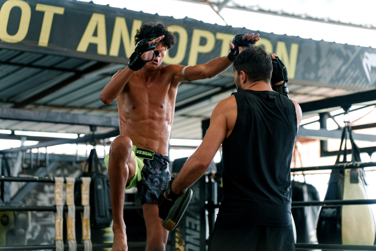 Nabil Anane attempts a jumping knee at The Inner Circle 25 Open Workout