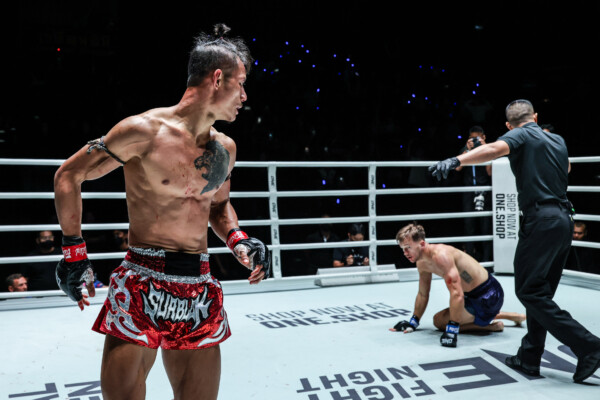 Muay Thai fighter Suablack Tor Pran49 looks over at a fallen Stephen Irvine