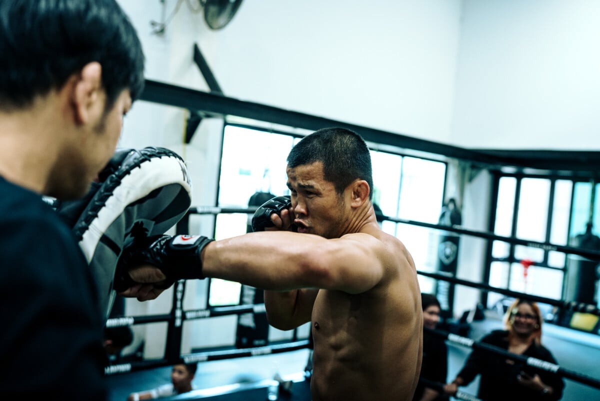 Nong O Hama throws a left hook on pad at The Inner Circle 38 Open Workout