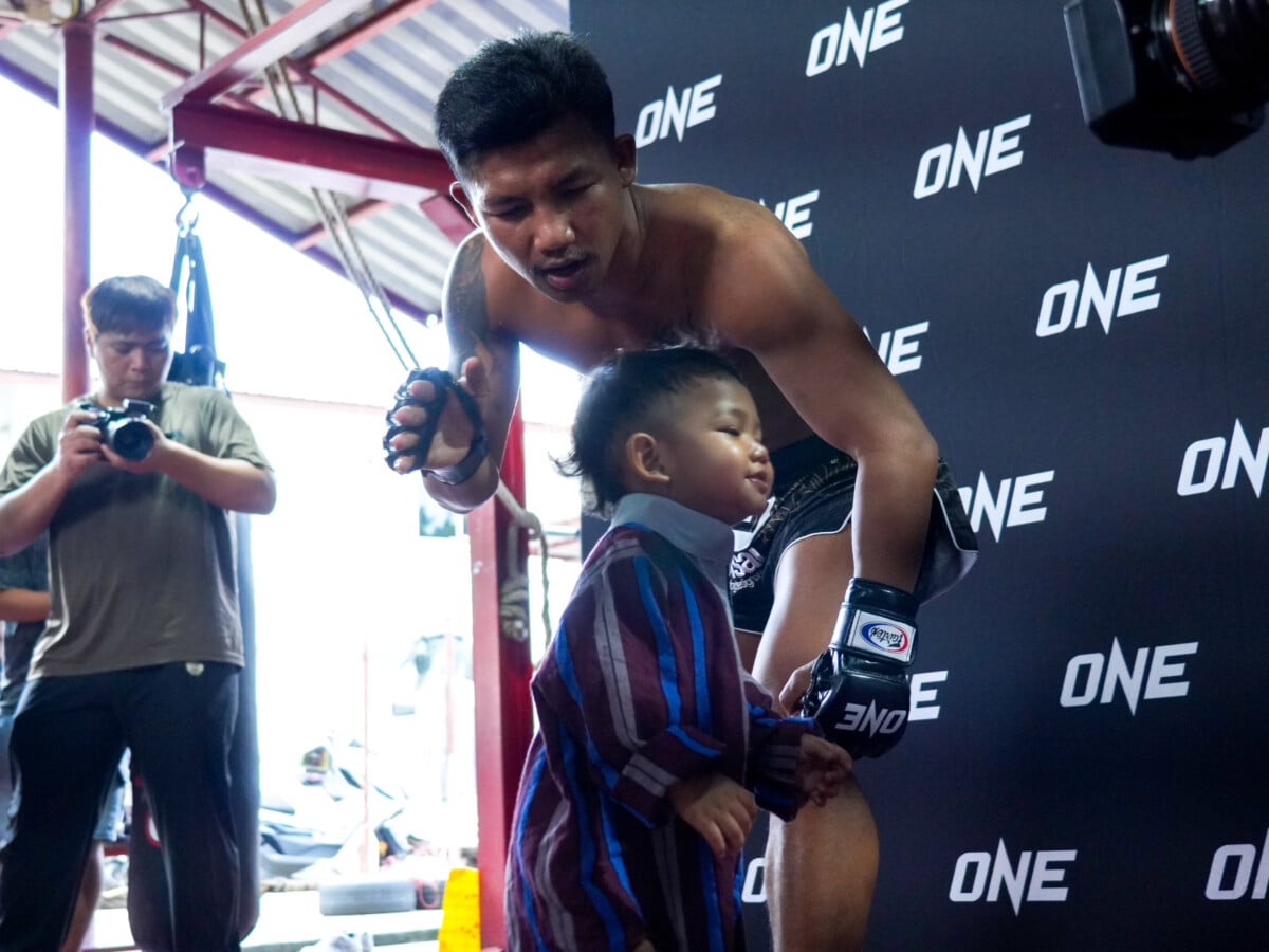 Rodtang Jitmuangnon shares a moment with his son during an open workout in Nonthaburi.