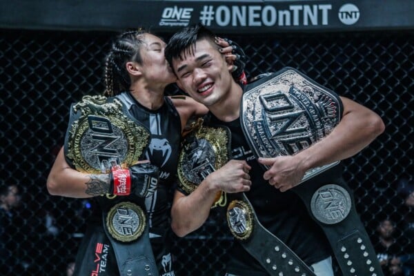 Angela Lee and Christian Lee with their ONE Championship belts at ONE: CENTURY