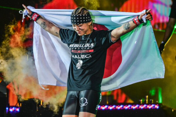 MMA fighter Itsuki Hirata walks to the Circle with the flag of Japan