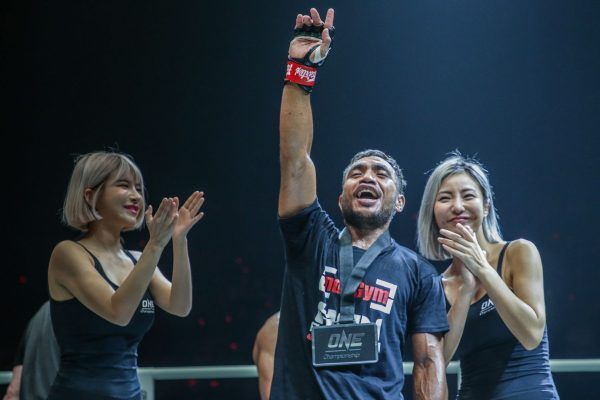 Indonesia's own Abro Fernandes raises his arm in vitory