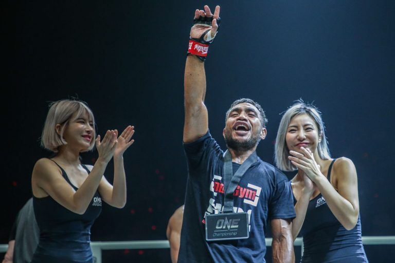 Indonesia's own Abro Fernandes raises his arm in vitory