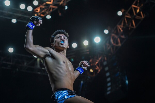 Lerdsila Phuket Top Team poses for the Bangkok crowd following his win