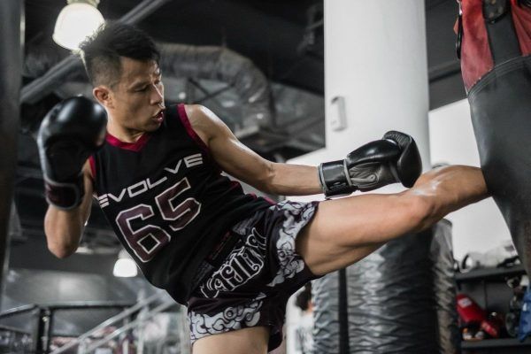 Multiple-time Muay Thai World Champion Sagetdao Petpayathai kicks a heavy bag at Evolve in Singapore