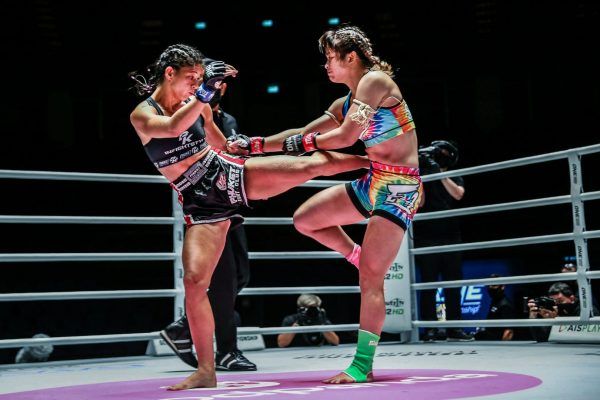 Brazilian Muay Thai fighter Allycia Hellen Rodrigues lands a roundhouse on Stamp Fairtex
