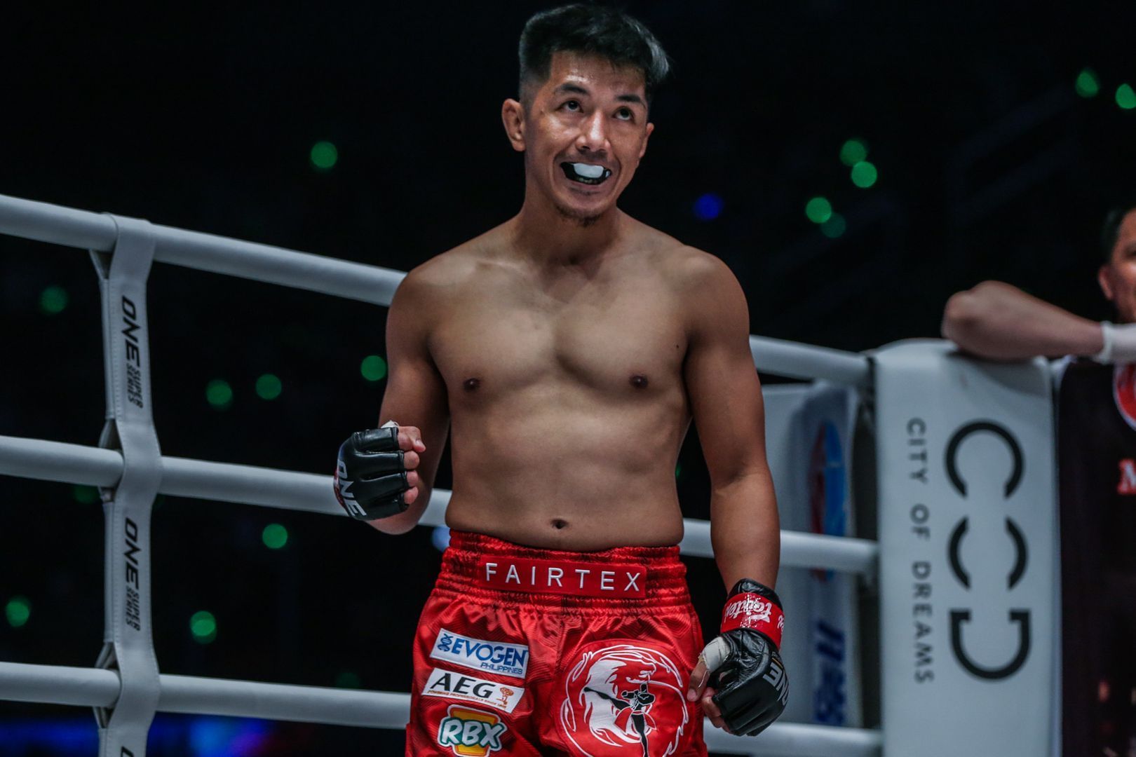 Geje Eustaquio bites his mouthguard in the ring