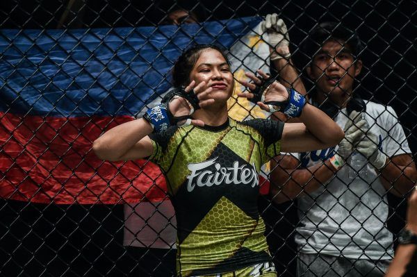 Philippine mixed martial artist stands against the fence