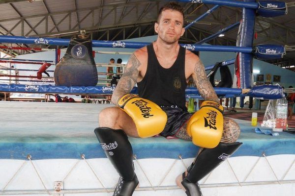 Irish Muay Thai World Champion Sean Clancy sits on the edge of the ring