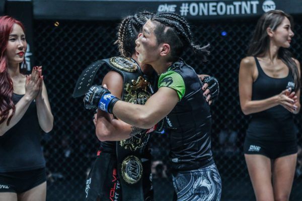 The two women's mixed martial arts champions of ONE Championship embrace after their rematch