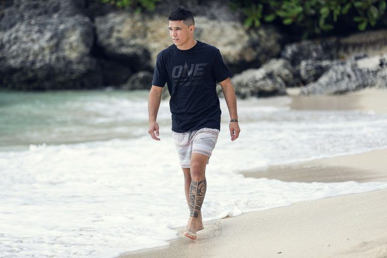 Australian mixed martial arts superstar Reece McLaren walks on the beach