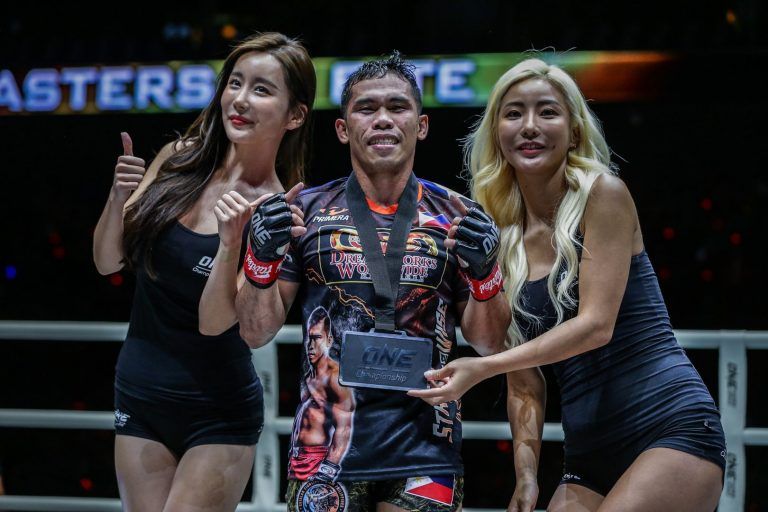Philippine mixed martial artist Robin Catalan with the ring girls and winner's medal