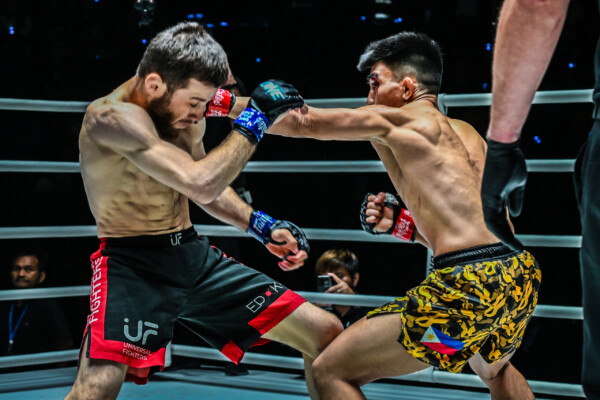 Joshua Pacio punches Mansur Malachiev in their first MMA fight