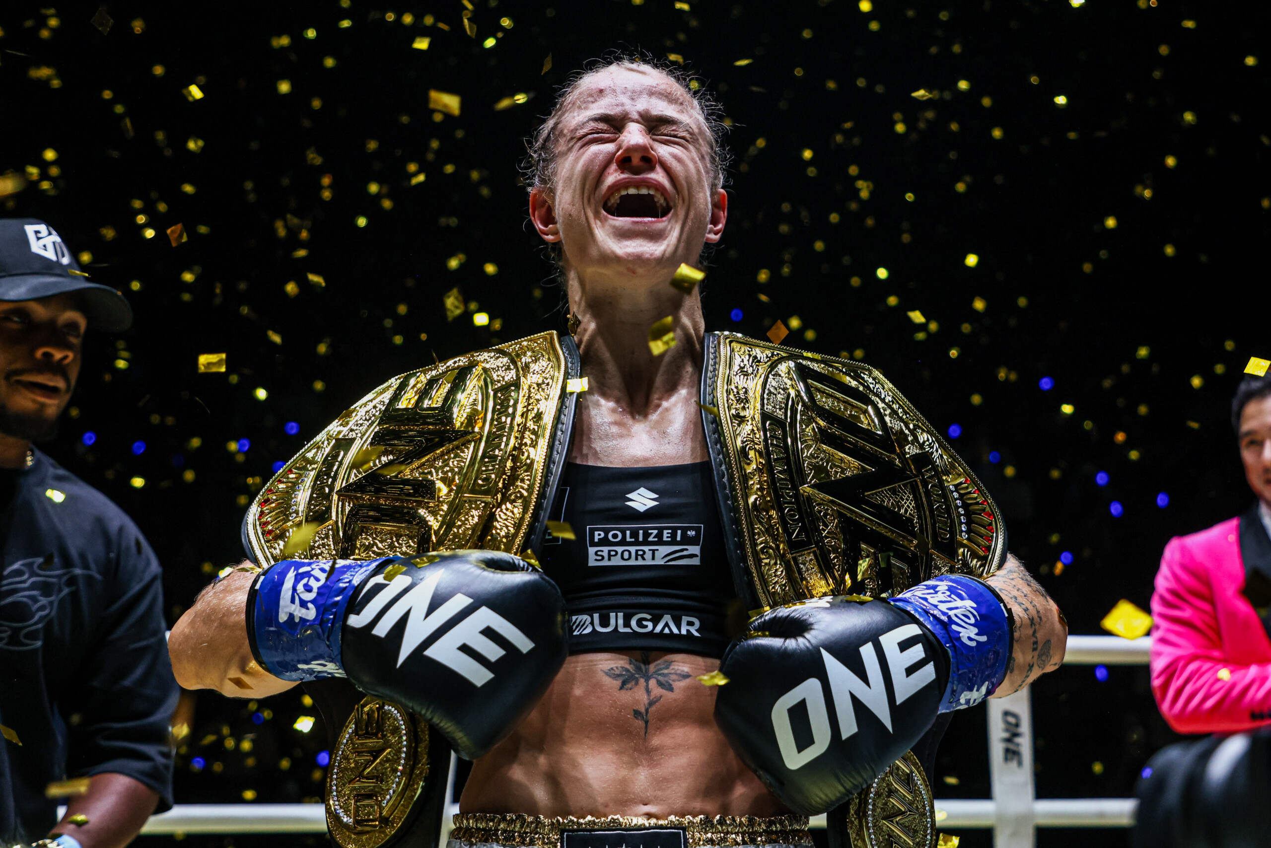 Stella Hemetsberger with two ONE Championship belts in the ring.