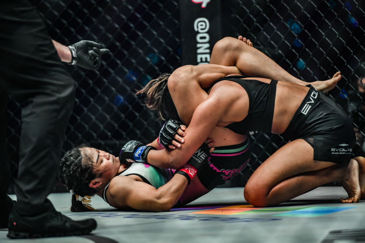 Stamp attacks with a triangle choke on Ritu Phogat at ONE: WINTER WARRIORS.